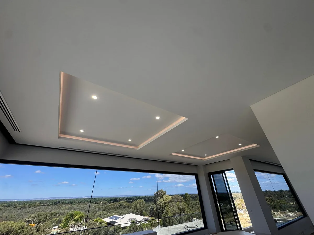 Open living room with an ocean view and a recessed ceiling detail with downlights